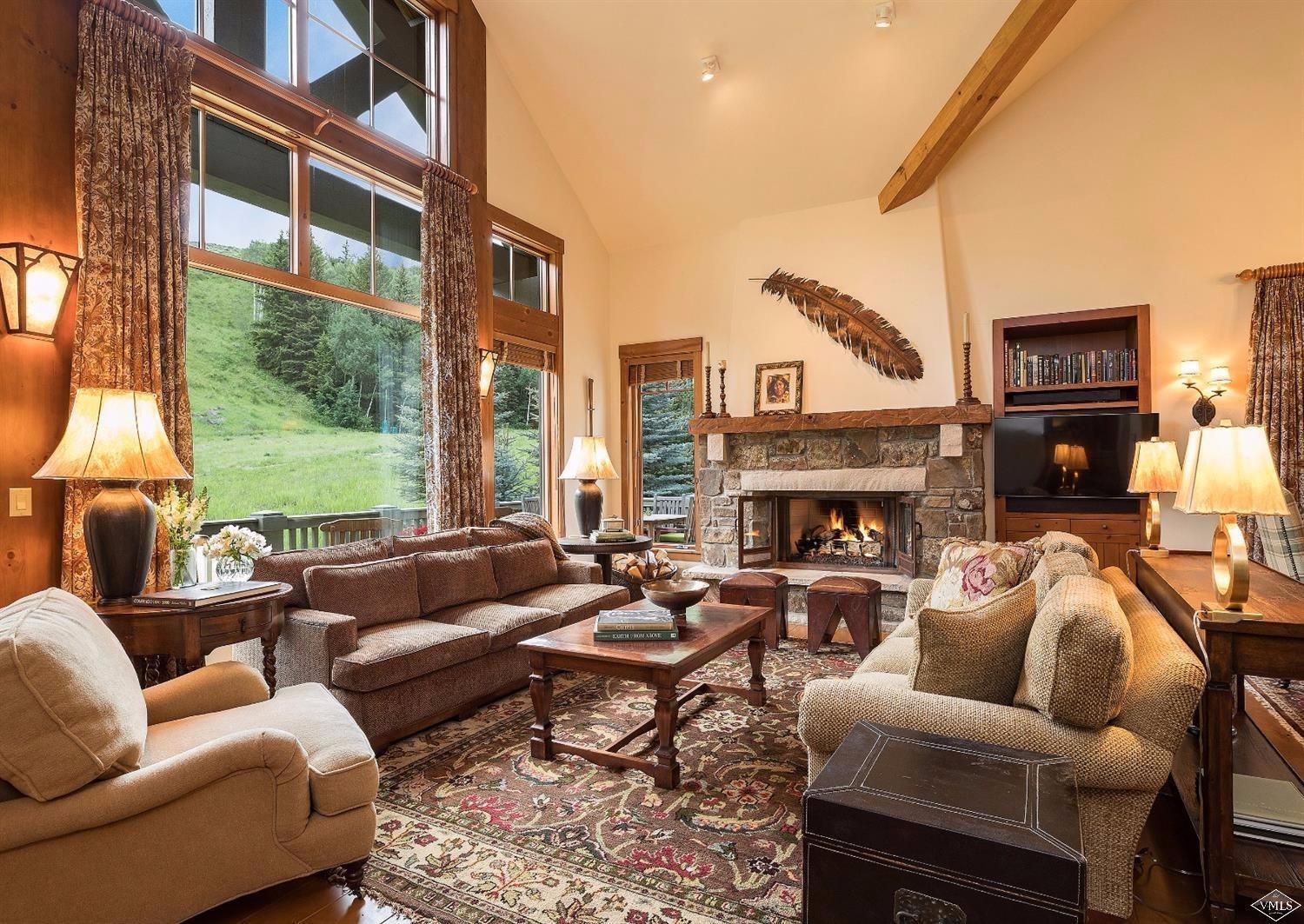 404 Cresta Road Edwards, CO 81632 - Photo 1 of 24 a living room with furniture fireplace and a large window