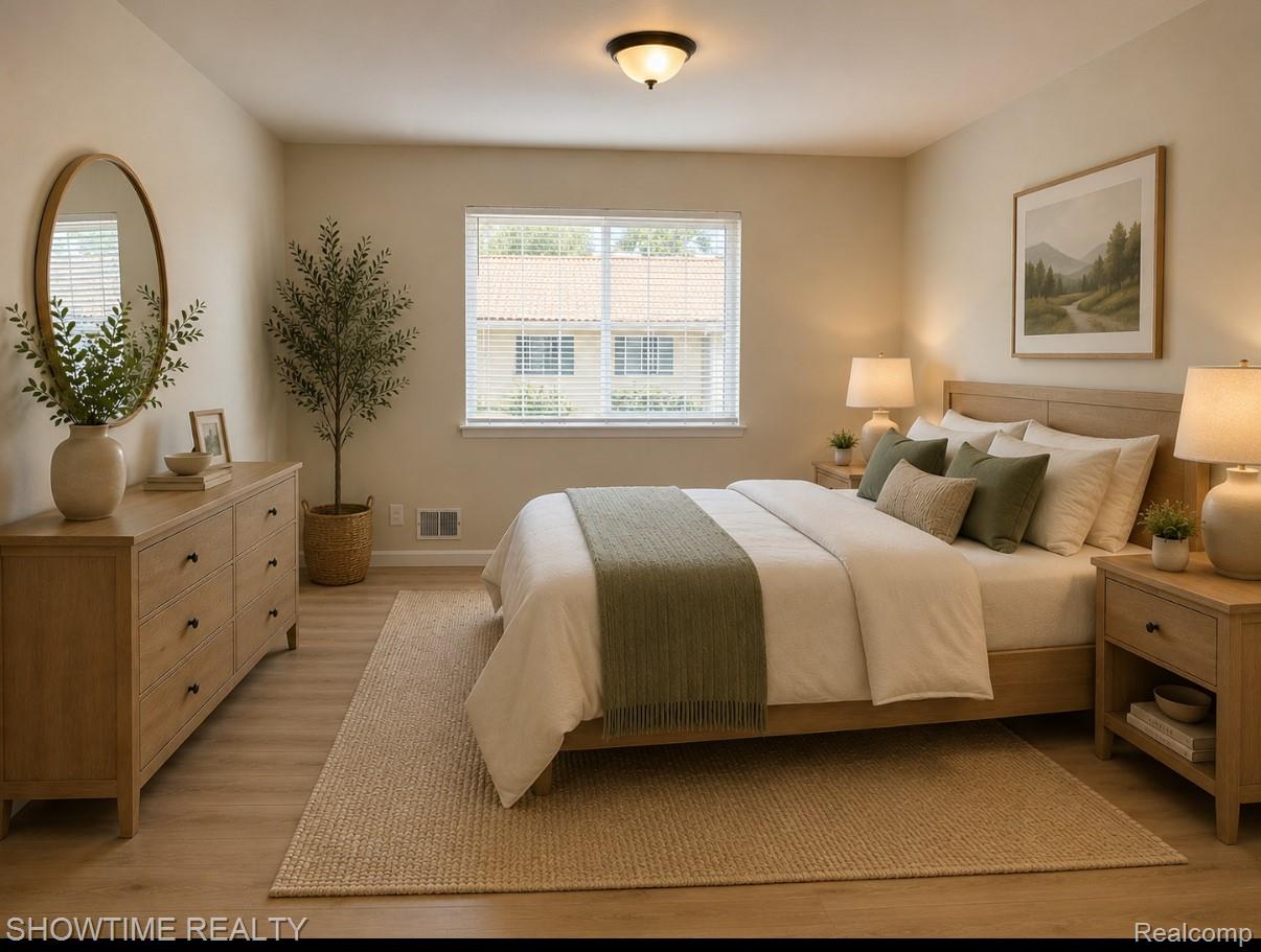 29141 Hayes Road Warren, MI 48088 - Photo 11 of 18 Recessed window with blinds, wood-finish flooring, and a ceiling-mounted light fixture