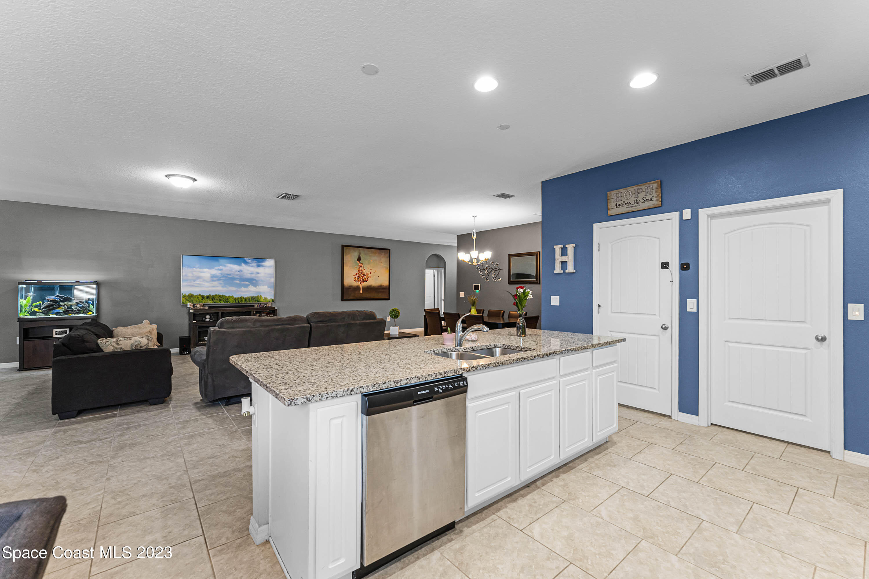 1803 Brockridge Road Kissimmee, FL 34744 - Photo 17 of 46 a large white kitchen with a stove a refrigerator a sink a dining table and chairs