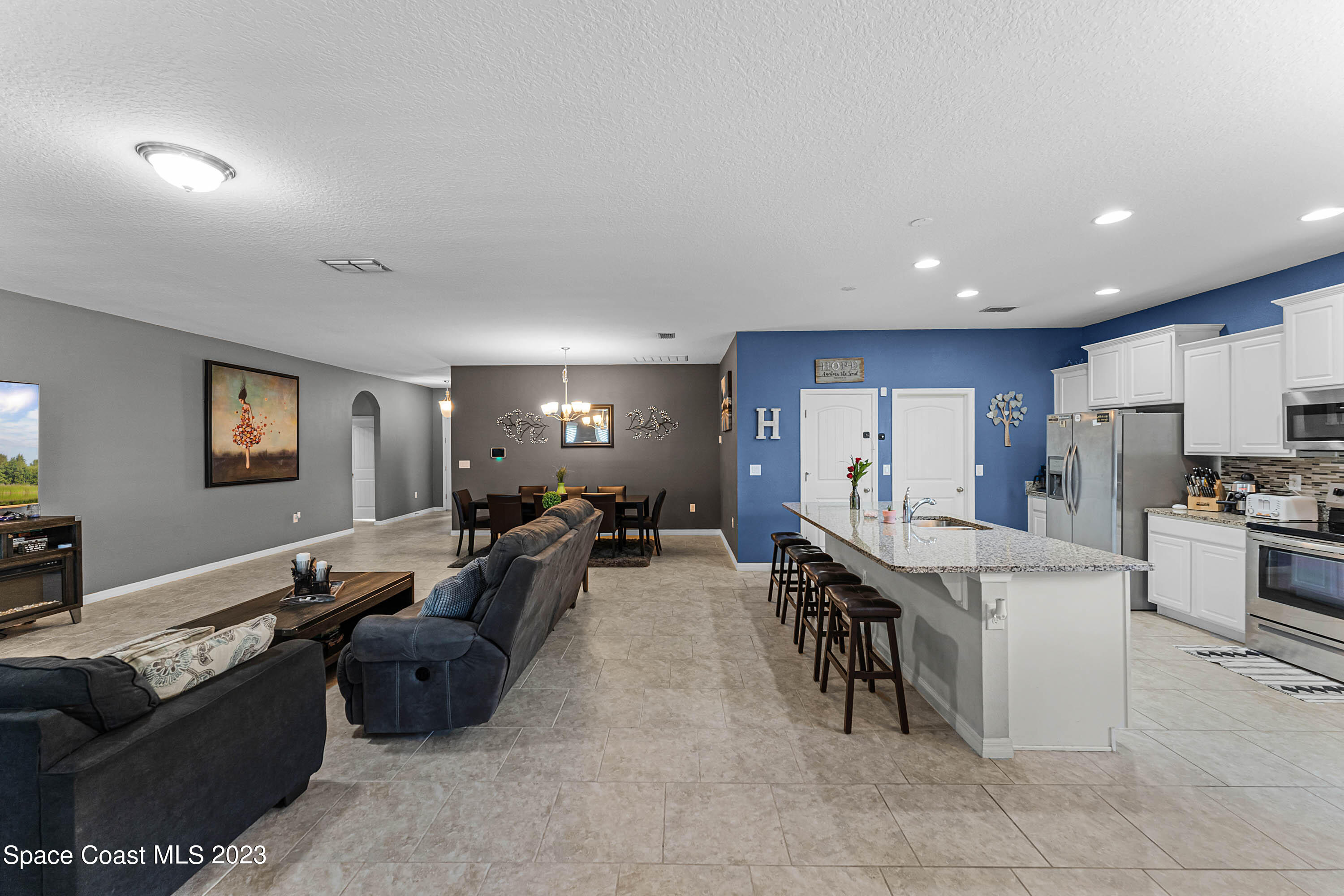 1803 Brockridge Road Kissimmee, FL 34744 - Photo 19 of 46 a living room with fireplace furniture and a flat screen tv