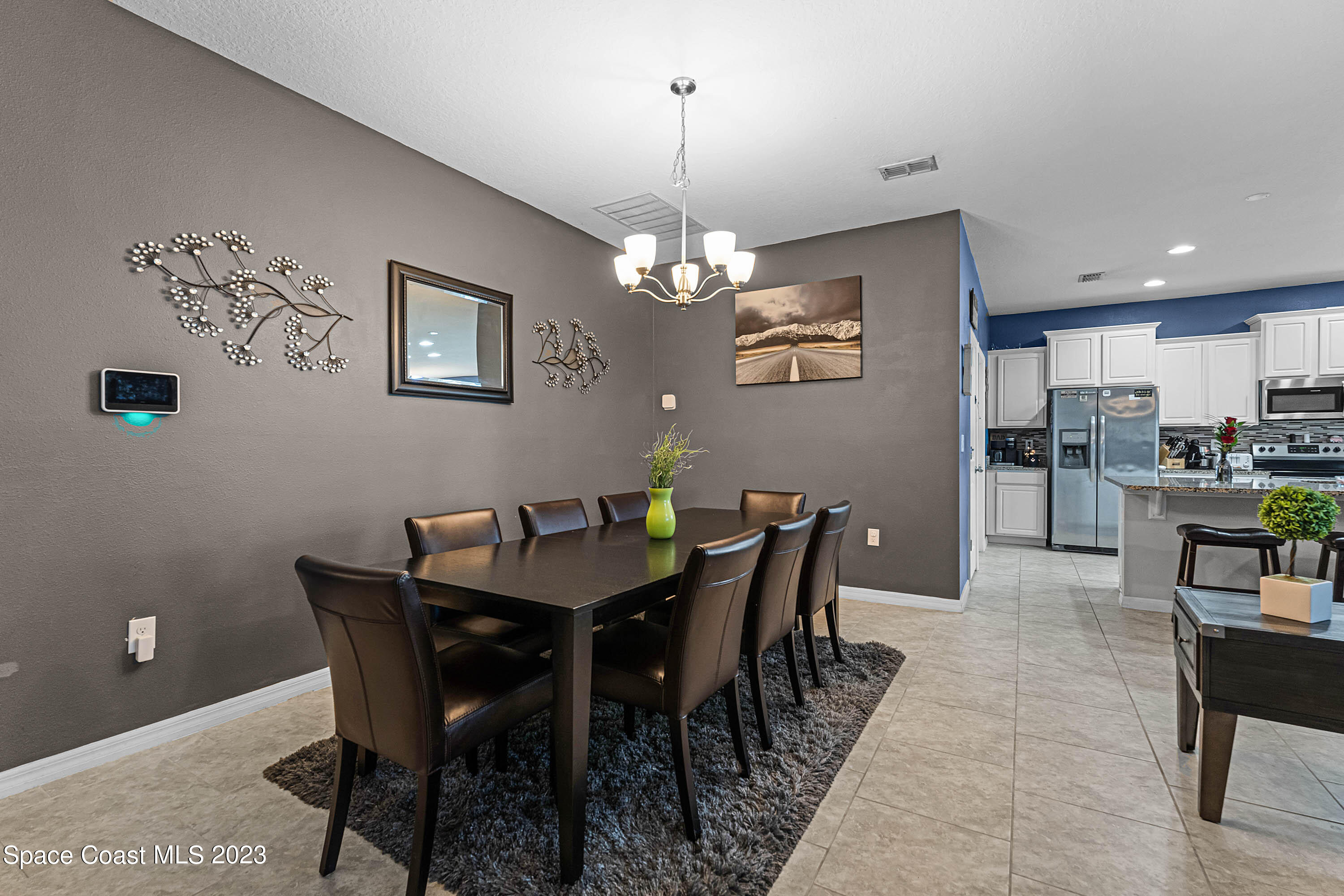 1803 Brockridge Road Kissimmee, FL 34744 - Photo 20 of 46 a view of a dining room with furniture and chandelier