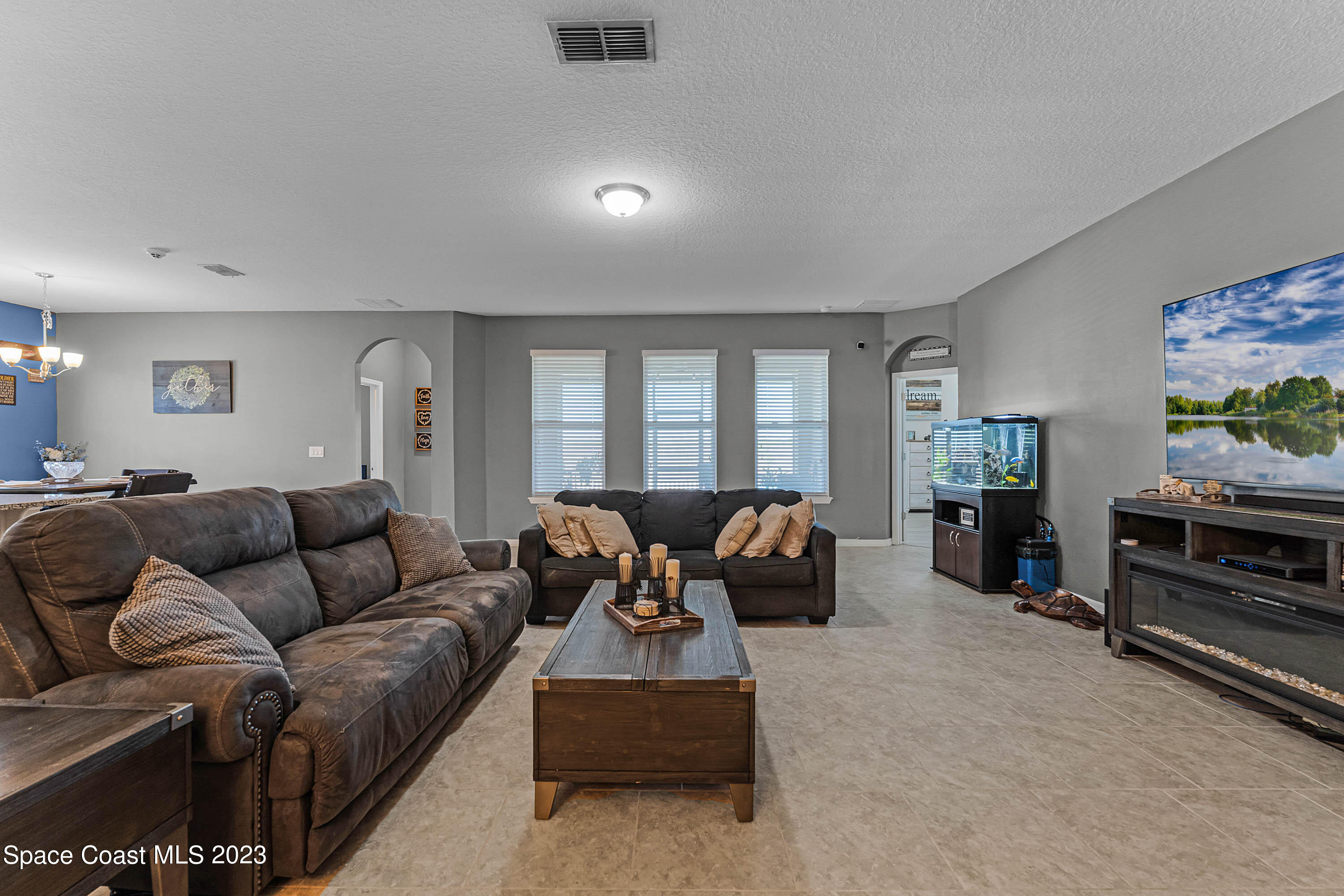 1803 Brockridge Road Kissimmee, FL 34744 - Photo 21 of 46 a living room with furniture a window and a flat screen tv