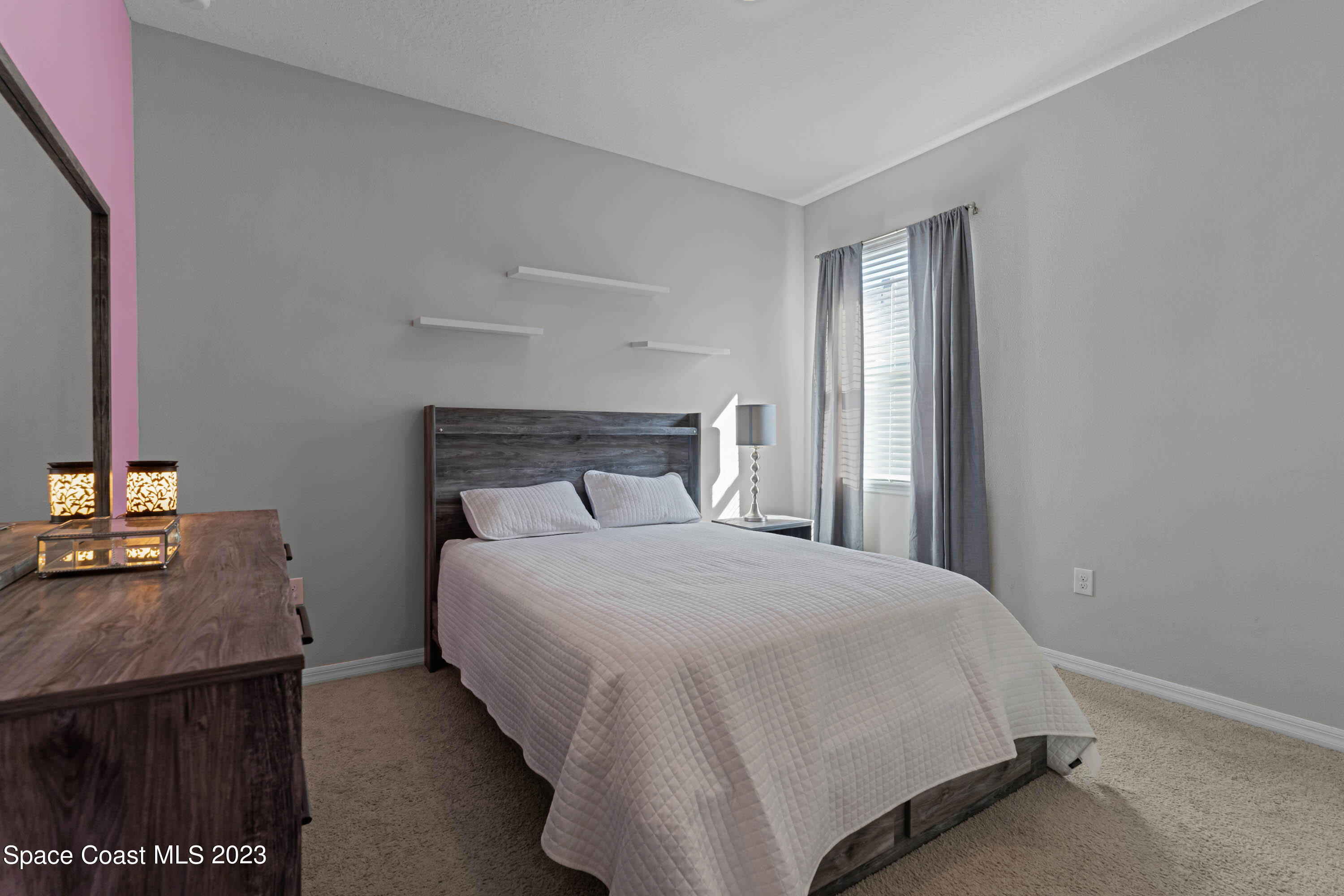 1803 Brockridge Road Kissimmee, FL 34744 - Photo 26 of 46 a bedroom with a bed and a desk