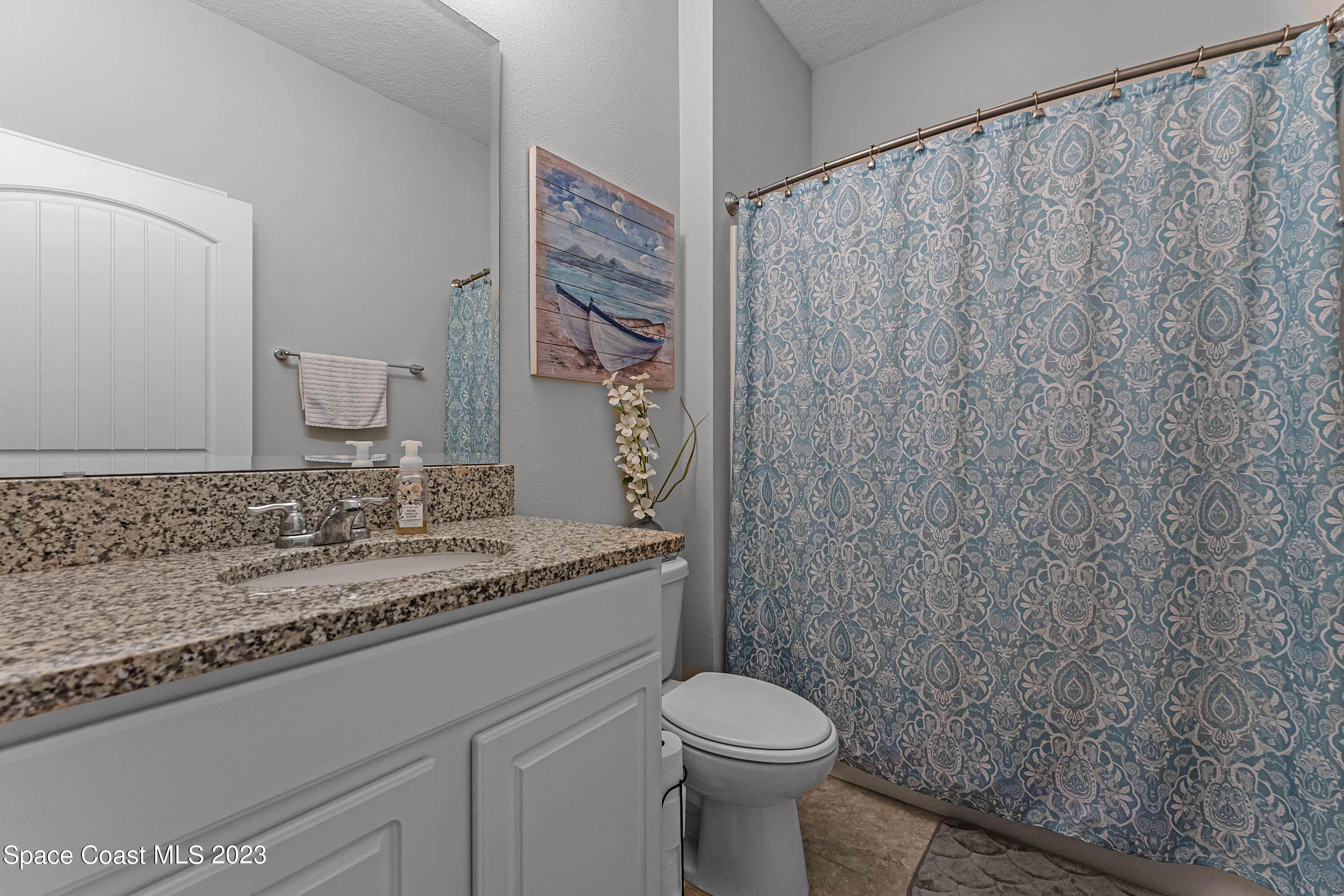 1803 Brockridge Road Kissimmee, FL 34744 - Photo 27 of 46 a bathroom with a granite countertop sink and a toilet