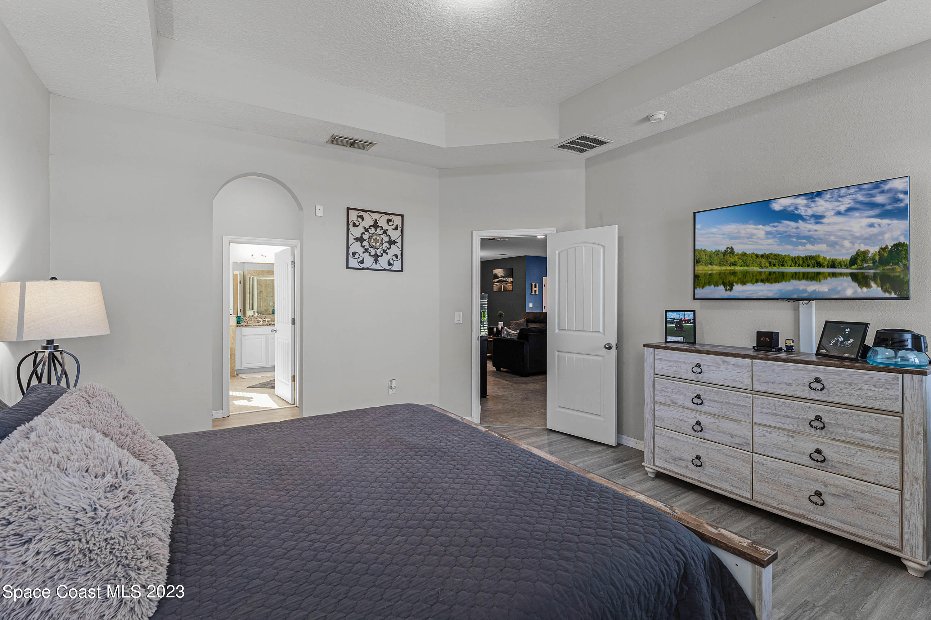 1803 Brockridge Road Kissimmee, FL 34744 - Photo 31 of 46 a bedroom with a bed and a flat screen tv