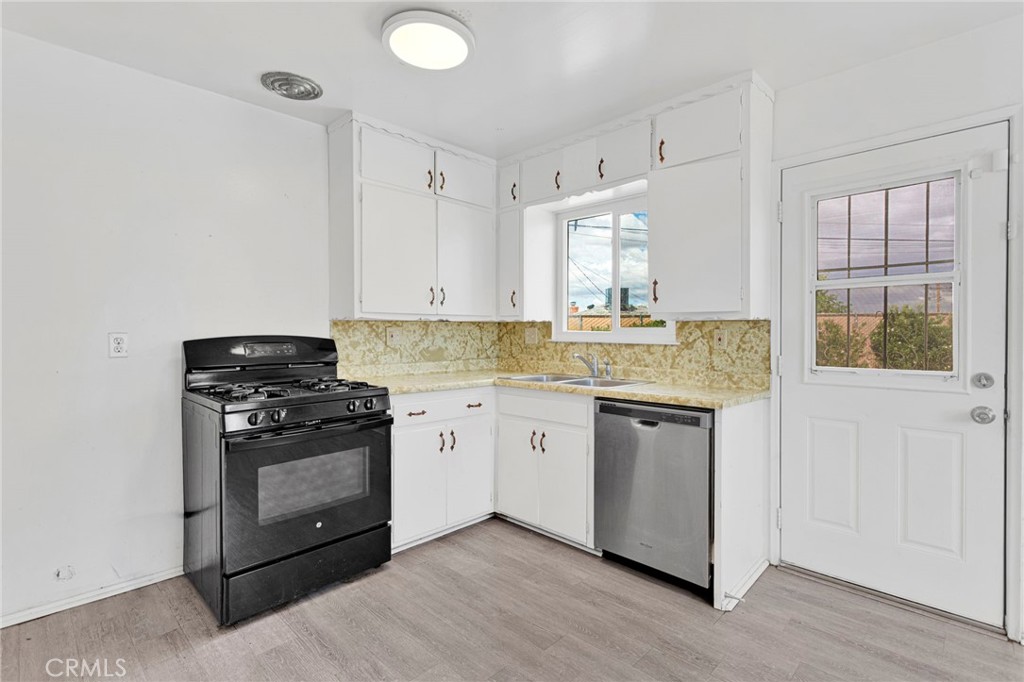 2567 Perth Court Barstow, CA 92311 - Photo 13 of 56 a kitchen with stainless steel appliances granite countertop a stove and a sink