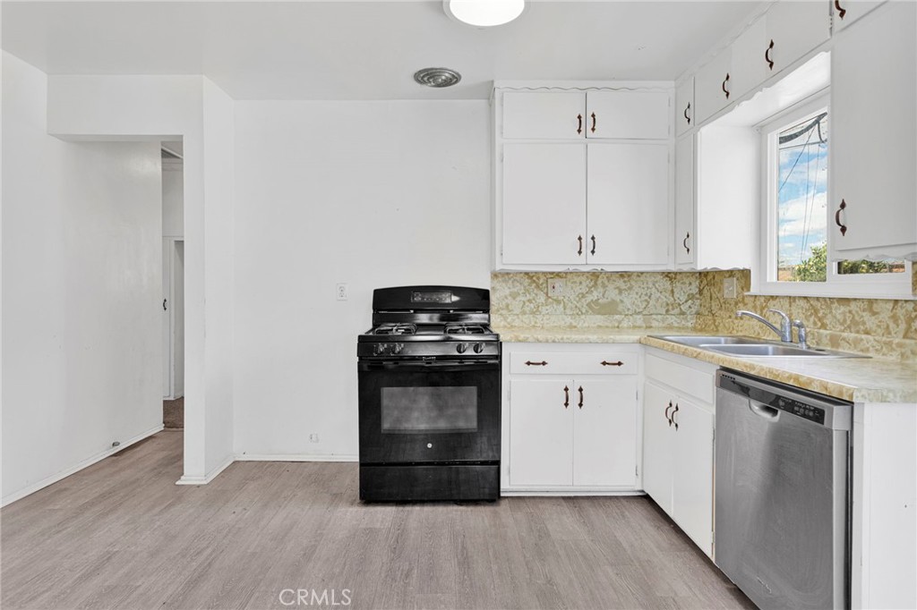 2567 Perth Court Barstow, CA 92311 - Photo 14 of 56 a kitchen with granite countertop a stove and a sink