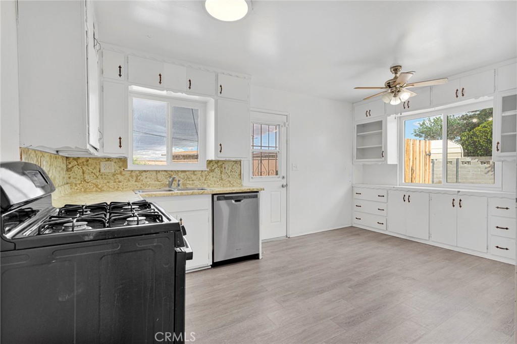2567 Perth Court Barstow, CA 92311 - Photo 15 of 56 a kitchen with granite countertop a stove a sink and a refrigerator