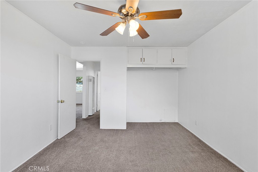 2567 Perth Court Barstow, CA 92311 - Photo 22 of 56 an empty room with chandelier fan and windows