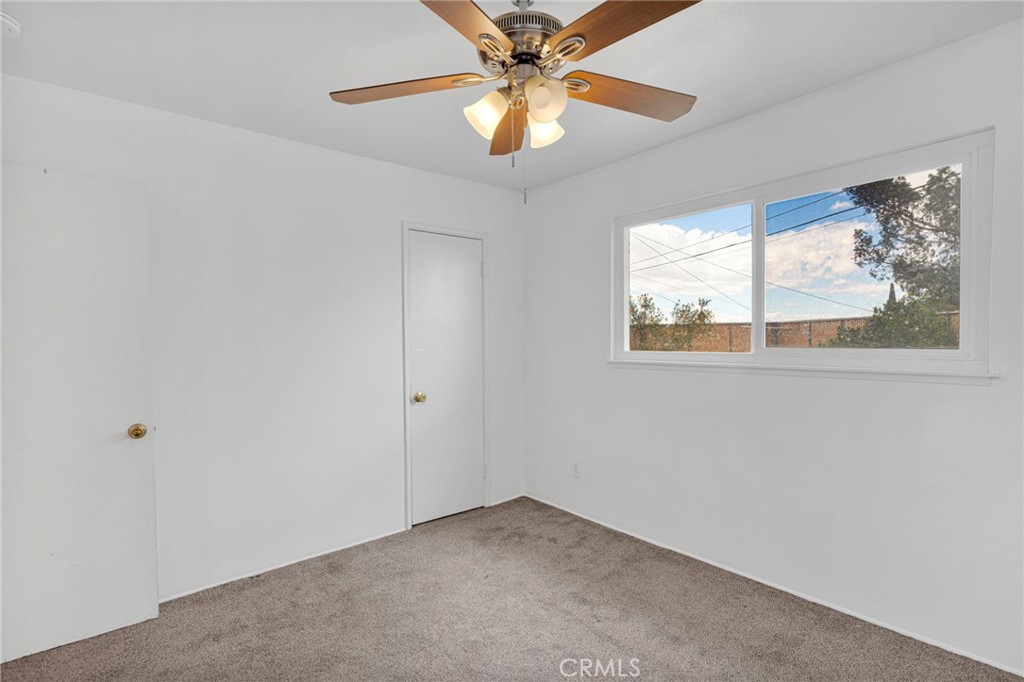 2567 Perth Court Barstow, CA 92311 - Photo 26 of 56 an empty room with a window and a fan