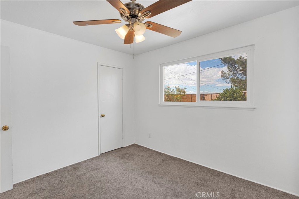 2567 Perth Court Barstow, CA 92311 - Photo 30 of 56 an empty room with windows and fan