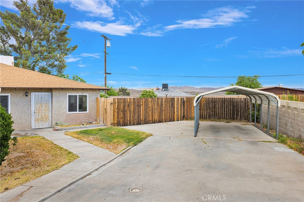 2567 Perth Court Barstow, CA 92311 - Photo 6 of 56 a backyard of a house with table and chairs