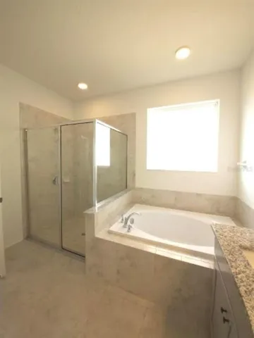 a view of a kitchen with a sink and dishwasher with white cabinets