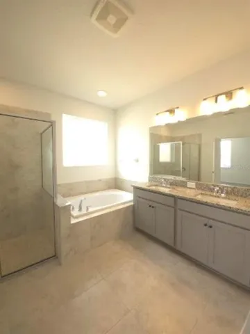 an empty room with a ceiling fan and a window