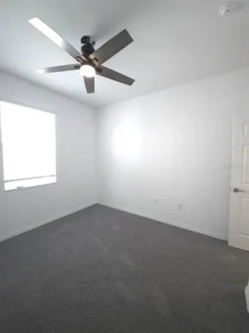 a bathroom with a granite countertop sink a toilet and a mirror