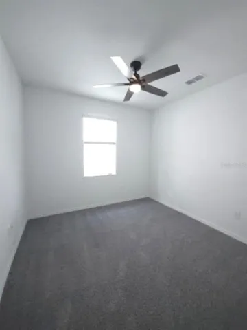 a view of a hallway with wooden floor and closet
