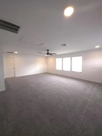 a bathroom with a granite countertop sink a toilet a mirror and shower