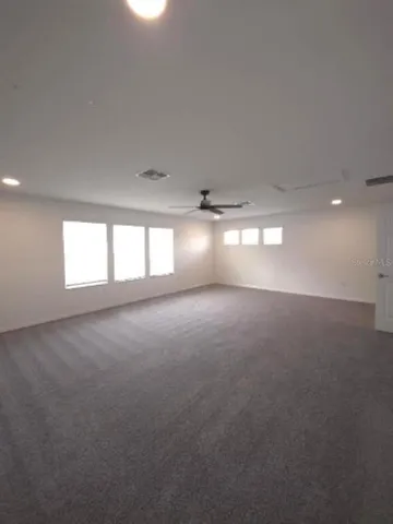 a bathroom with a granite countertop sink a toilet and shower