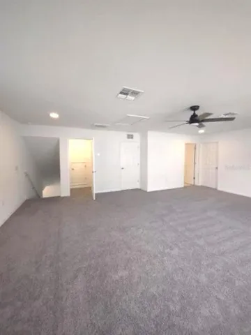a bathroom with a granite countertop sink a toilet and mirror