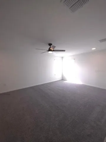 a view of an empty room and a window