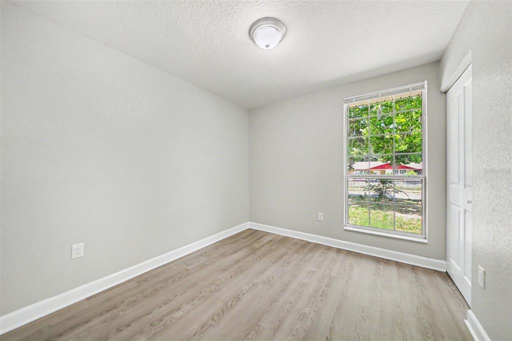 1109 Inland Street Leesburg, FL 34748 - Photo 10 of 15 wooden floor in an empty room with a window