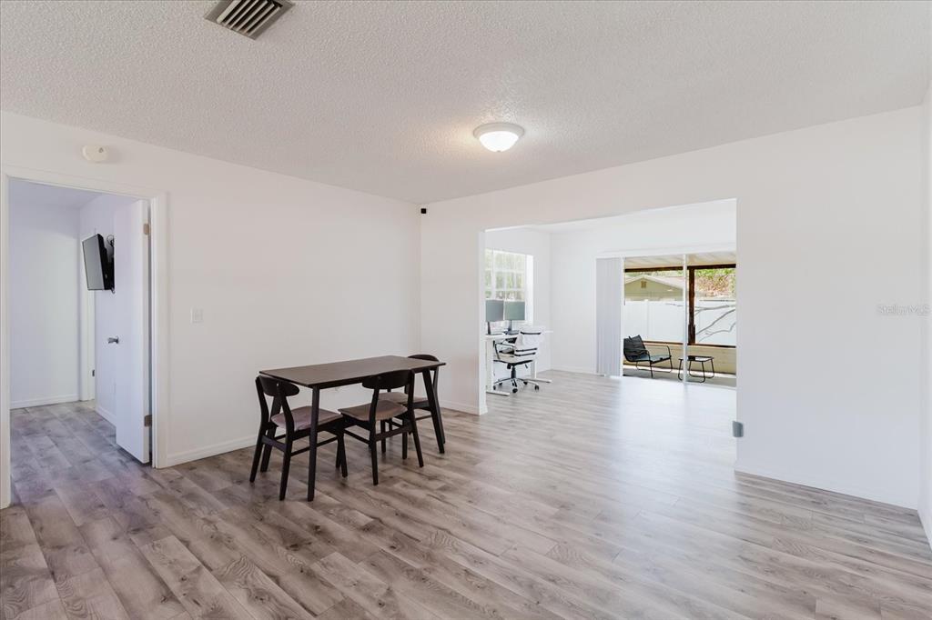 12526 Elgin Boulevard Spring Hill, FL 34609 - Photo 8 of 33 a dining room with furniture and wooden floor