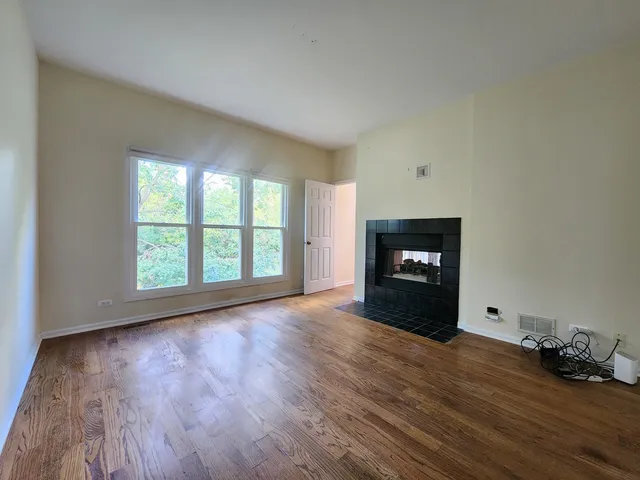 a view of a room window and wooden floor