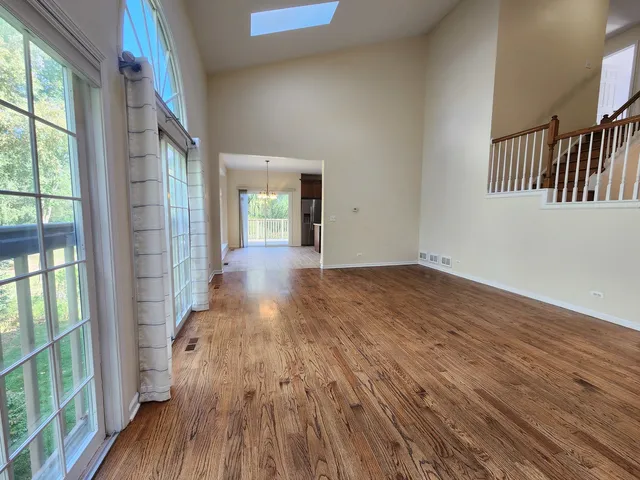 a view of interior space with wooden floor and windows