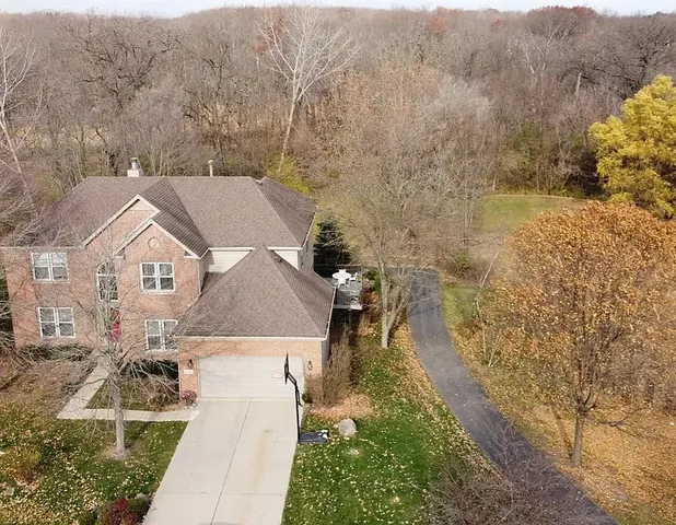 an aerial view of a house with a yard