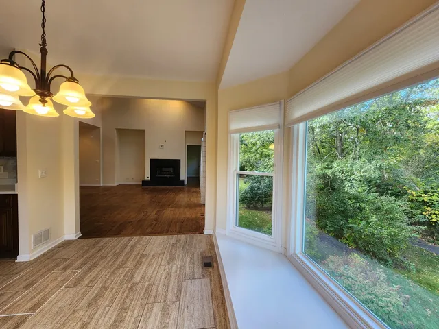 a view of a living room hardwood floor and a large window