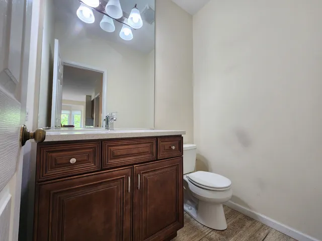 a bathroom with a toilet a sink and mirror