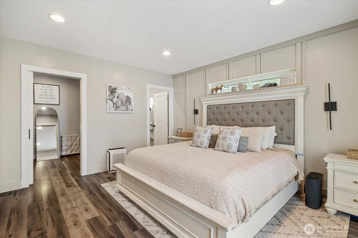 26709 Entwhistle Road East Buckley, WA 98321 - Photo 21 of 40 a bedroom with a large bed and a wooden floor