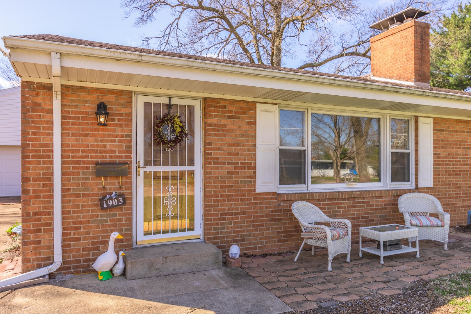 1903 Croxton Avenue Bloomington, IL 61701 - Photo 34 of 55 a front view of a house with a chairs and table