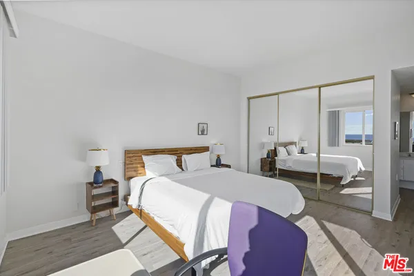 a bed room with a bed and a chair