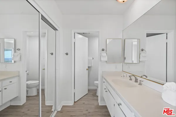 a spacious bathroom with a tub sink and mirror