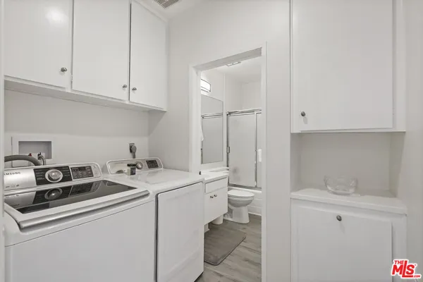 a utility room with sink dryer and washer