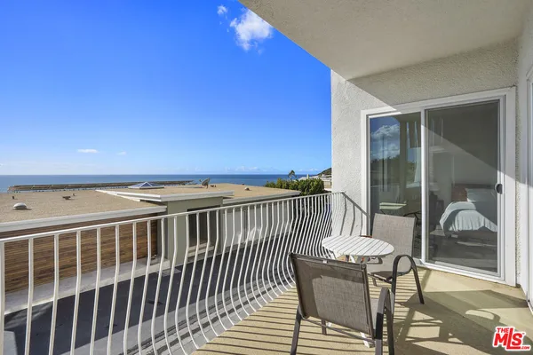 a view of a balcony with chair and table
