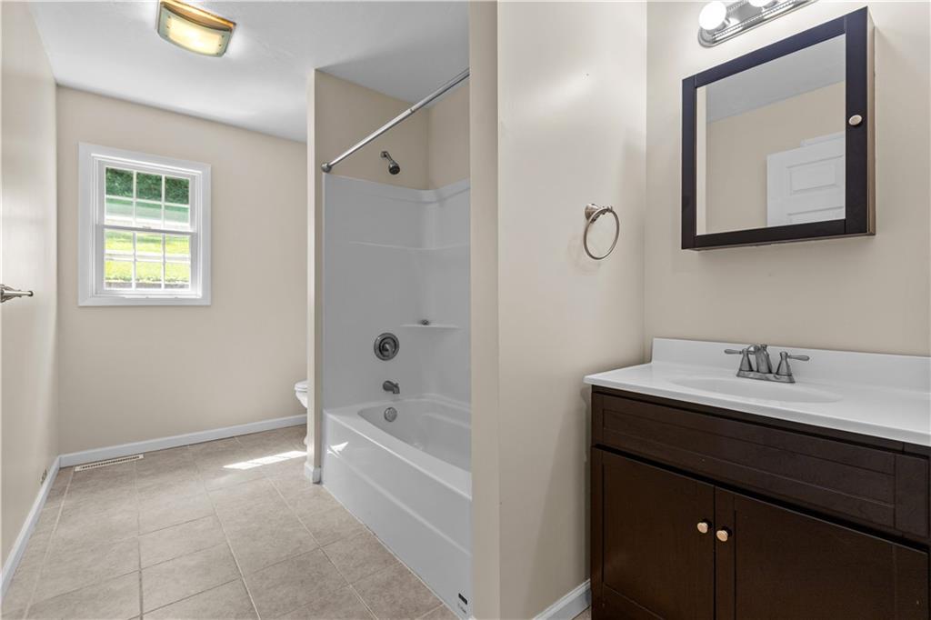 509 Quail Hill Road Normalville, PA 15469 - Photo 13 of 26 a bathroom with a tub a sink and mirror