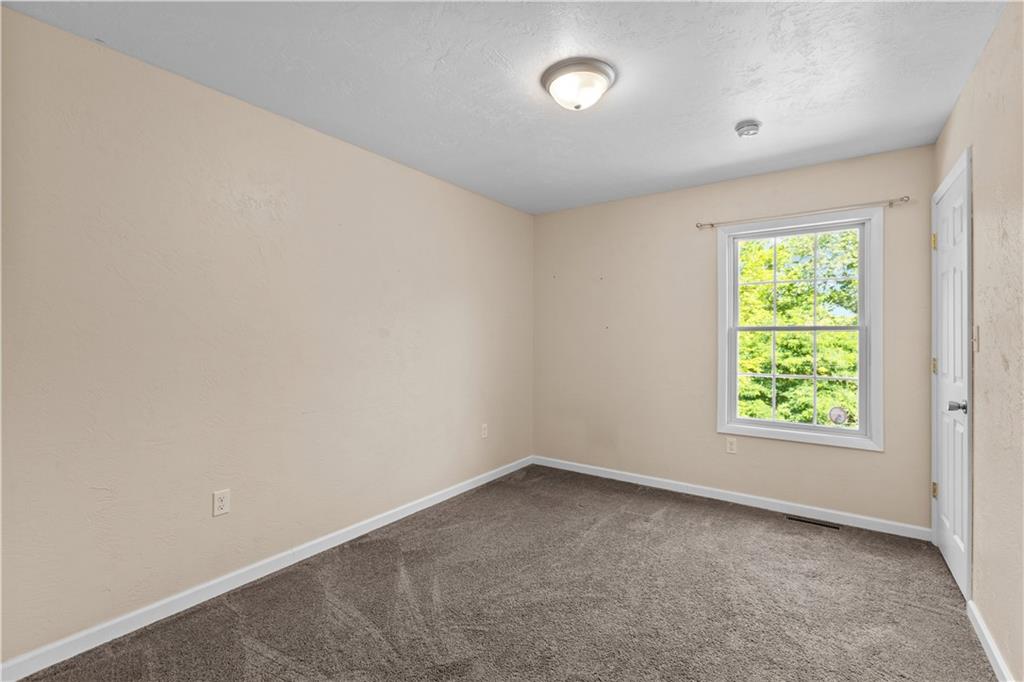 509 Quail Hill Road Normalville, PA 15469 - Photo 14 of 26 an empty room with windows