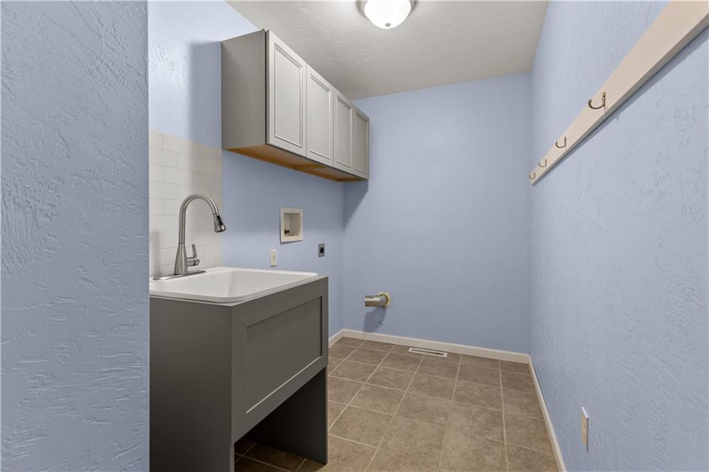 509 Quail Hill Road Normalville, PA 15469 - Photo 15 of 26 a utility room with sink dryer and washer
