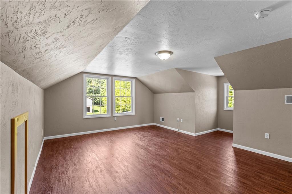 509 Quail Hill Road Normalville, PA 15469 - Photo 16 of 26 an empty room with wooden floor and windows