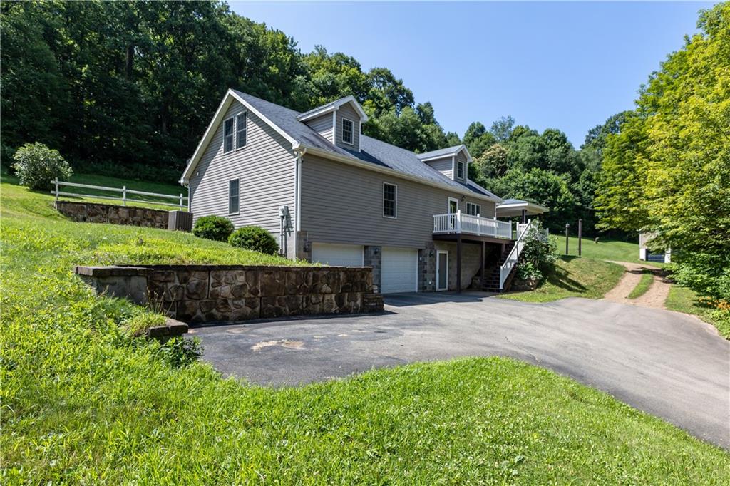 509 Quail Hill Road Normalville, PA 15469 - Photo 22 of 26 a view of a house with a yard and plants