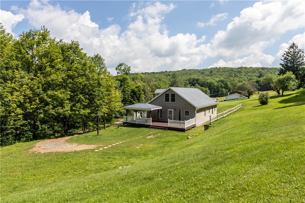 509 Quail Hill Road Normalville, PA 15469 - Photo 24 of 26 a view of a house with a big yard and large trees