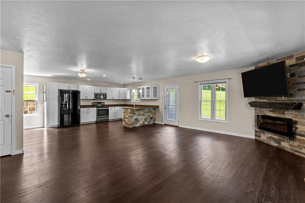 509 Quail Hill Road Normalville, PA 15469 - Photo 5 of 26 a view of a livingroom with furniture flat screen tv and window