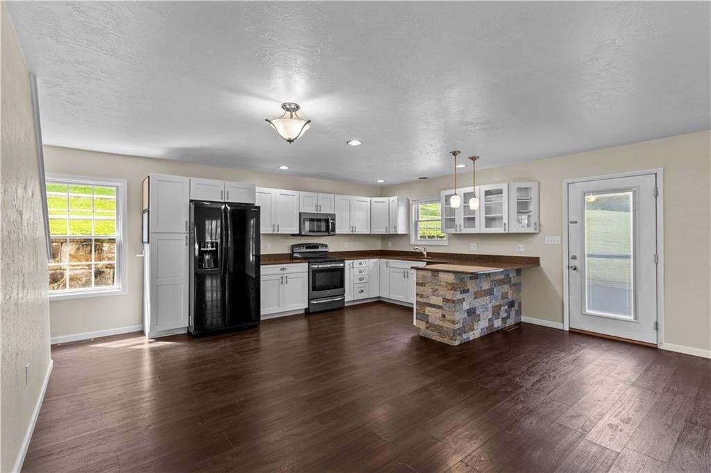 509 Quail Hill Road Normalville, PA 15469 - Photo 6 of 26 a view of a kitchen with stainless steel appliances refrigerator stove microwave and cabinets