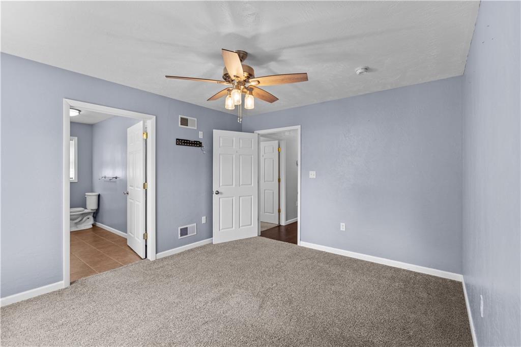 509 Quail Hill Road Normalville, PA 15469 - Photo 9 of 26 a view of a big room with chandelier fan and a bathroom