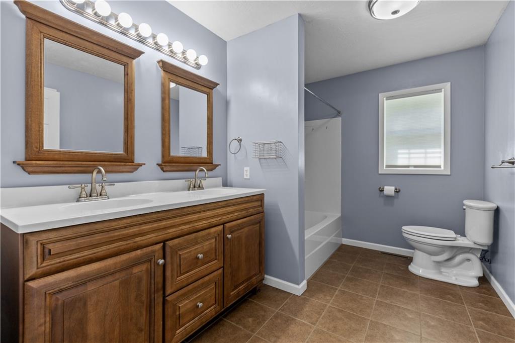 509 Quail Hill Road Normalville, PA 15469 - Photo 10 of 26 a spacious bathroom with a toilet sink and mirror