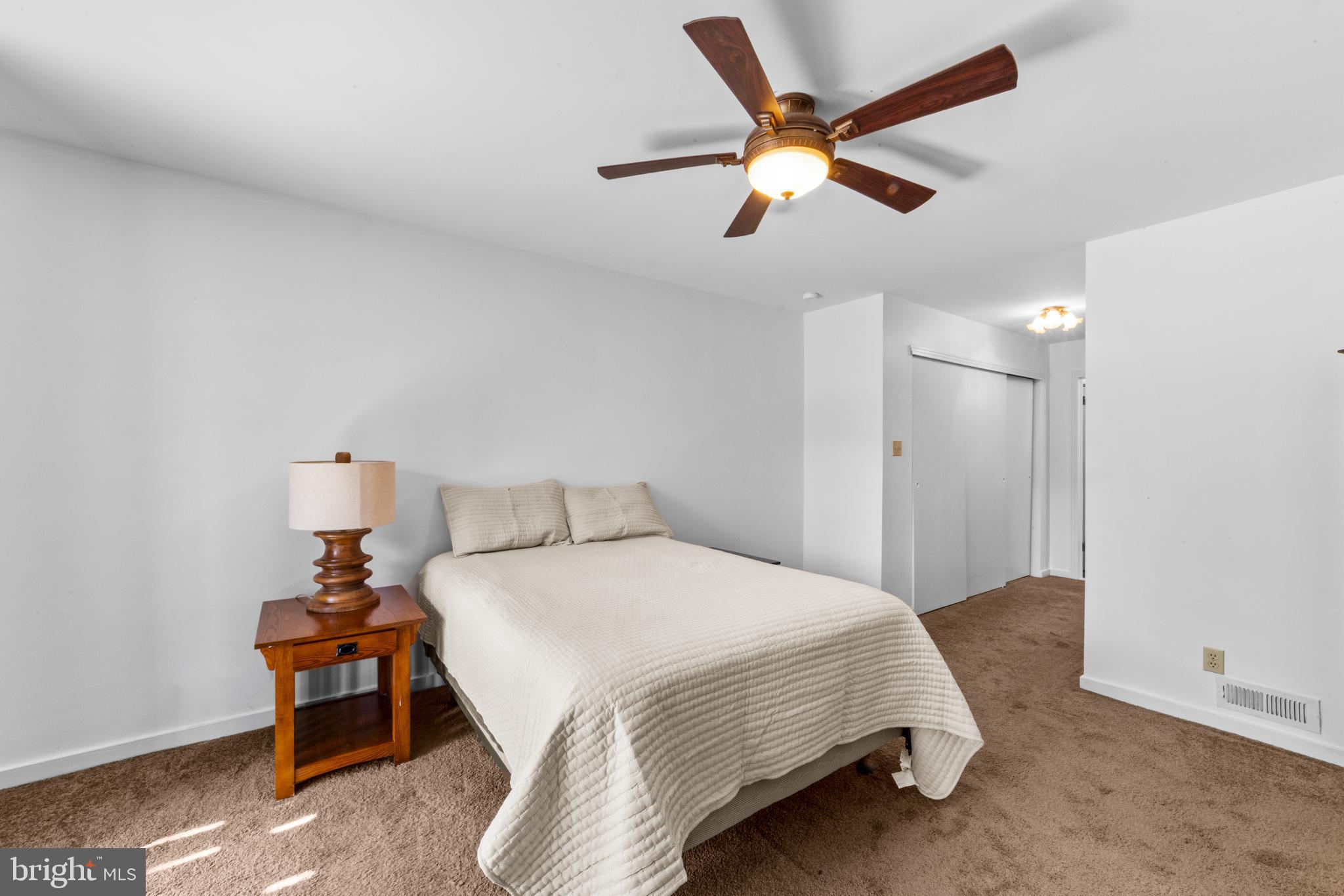 1202 Augusta Circle Mount Laurel, NJ 08054 - Photo 14 of 25 a bedroom with a bed and a chandelier
