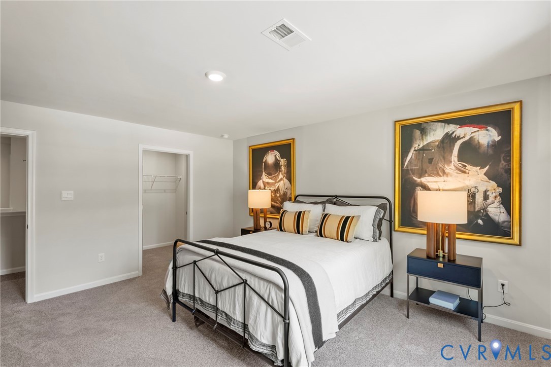 7745 Arbor Marsh Terrace New Kent, VA 23124 - Photo 15 of 30 a bedroom with a bed and a painting on the wall