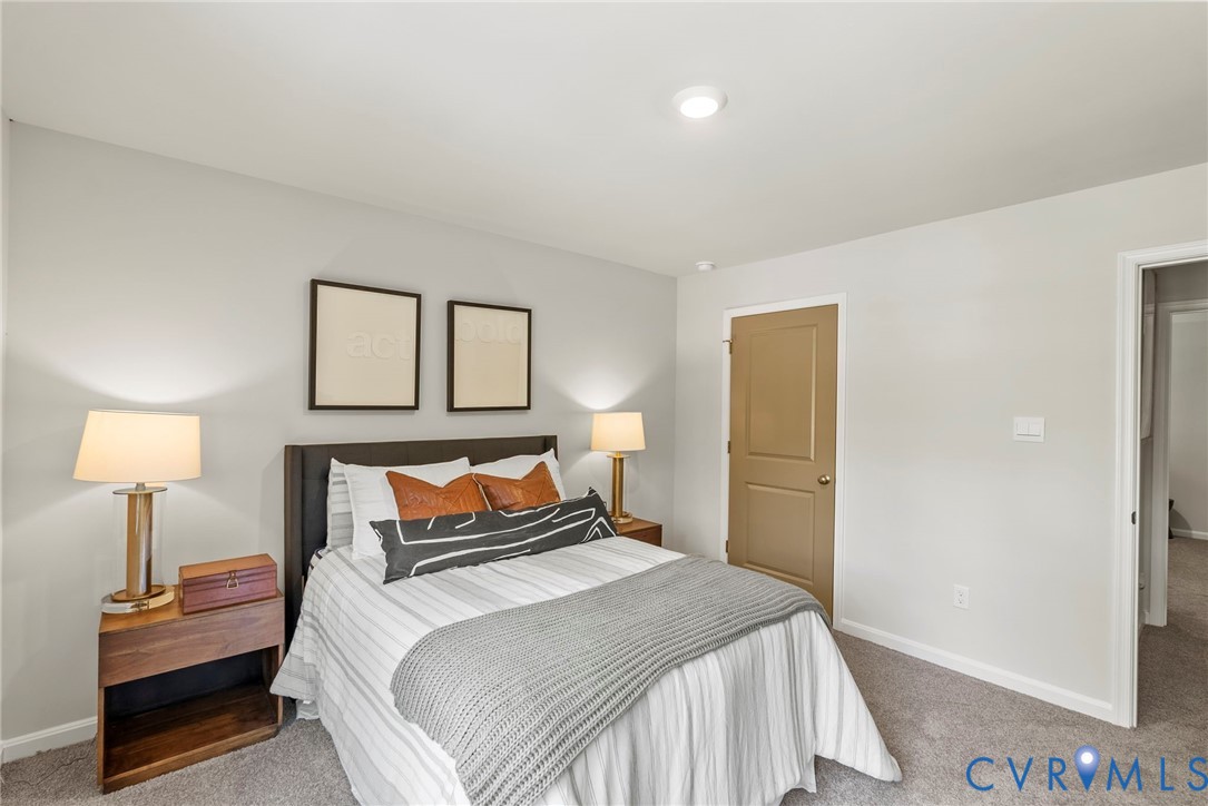 7745 Arbor Marsh Terrace New Kent, VA 23124 - Photo 18 of 30 a bedroom with a bed and a lamp